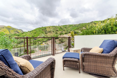 Example of a mid-sized minimalist backyard second story deck design in Orange County