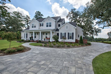 Inspiration for a mid-sized timeless beige two-story vinyl exterior home remodel in Miami with a shingle roof
