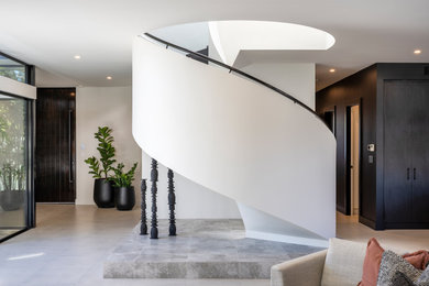 Photo of a mid-sized contemporary wood curved staircase in Melbourne with wood risers and wood railing.