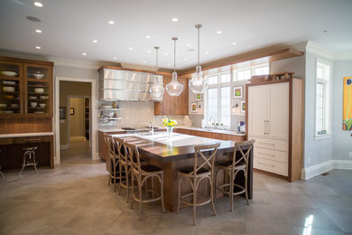 Large transitional l-shaped beige floor open concept kitchen photo in DC Metro with an undermount sink, flat-panel cabinets, medium tone wood cabinets, beige backsplash, stainless steel appliances and an island