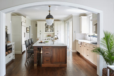 Open concept kitchen - large transitional medium tone wood floor and brown floor open concept kitchen idea in San Francisco with a farmhouse sink, flat-panel cabinets, white cabinets, quartz countertops, white backsplash, terra-cotta backsplash, stainless steel appliances and an island