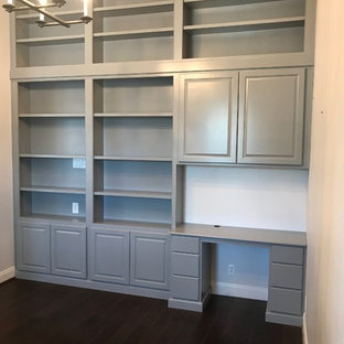 This is an example of a small modern home office and library in Other with a reading nook, grey walls and a built-in desk.
