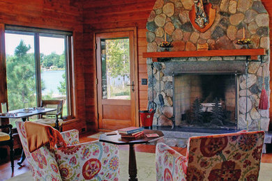 Transitional medium tone wood floor sunroom photo in Minneapolis with a stone fireplace