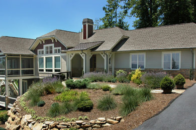 Example of a large arts and crafts gray two-story concrete fiberboard house exterior design in Other with a clipped gable roof and a shingle roof