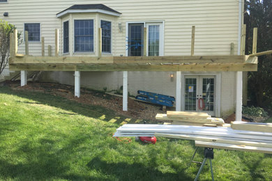 Example of a mid-sized backyard ground level deck design in Baltimore