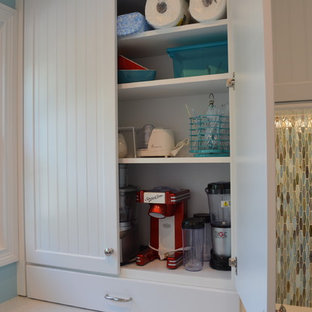 Photo of a medium sized classic utility room in Cleveland with a submerged sink, recessed-panel cabinets, white cabinets, engineered stone countertops, blue walls and ceramic flooring.