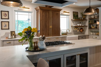 Farmhouse l-shaped kitchen photo in Atlanta with shaker cabinets, quartz countertops, quartz backsplash and an island