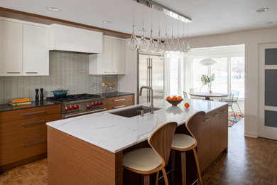 Mid-sized trendy galley brown floor eat-in kitchen photo in Orlando with an undermount sink, flat-panel cabinets, multicolored backsplash, matchstick tile backsplash, an island, medium tone wood cabinets and brown countertops