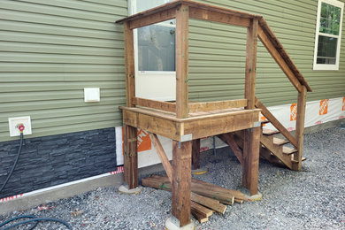 Inspiration for a small modern wood railing deck remodel in Toronto
