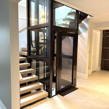 Project #136 | Modern Floating Staircase Encircling Glass Elevator