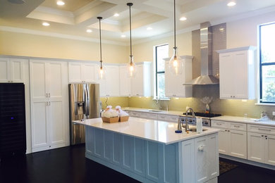 Example of a large transitional l-shaped dark wood floor open concept kitchen design in Orlando with an undermount sink, shaker cabinets, white cabinets, granite countertops, white backsplash, subway tile backsplash, stainless steel appliances and an island