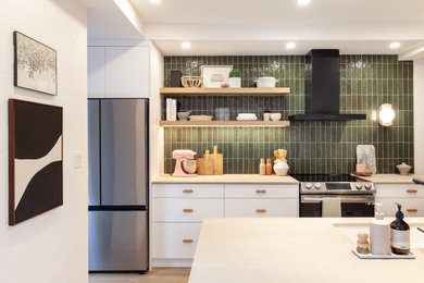 Kitchen pantry - small scandinavian galley vinyl floor and brown floor kitchen pantry idea in Toronto with an undermount sink, flat-panel cabinets, white cabinets, quartz countertops, green backsplash, ceramic backsplash, stainless steel appliances, no island and beige countertops