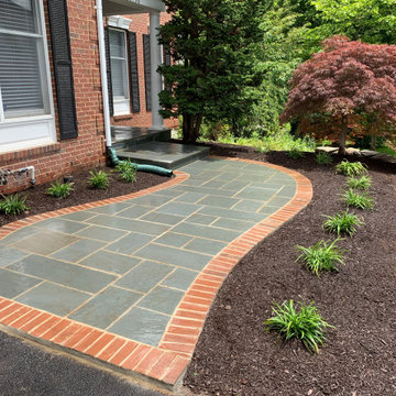 Limestone walkway with brick ascent to match house