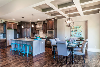 Large elegant galley dark wood floor eat-in kitchen photo in Kansas City with an undermount sink, raised-panel cabinets, dark wood cabinets, granite countertops, gray backsplash, mosaic tile backsplash, stainless steel appliances and an island