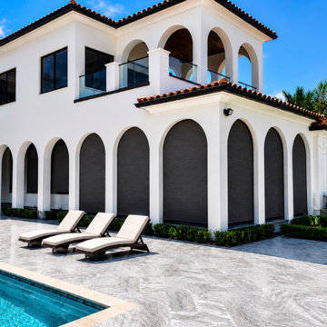 Mediterranean Estate with Roll-Down Hurricane Screens Across Arched Loggia — Boc