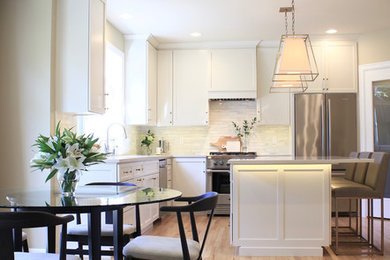 Eat-in kitchen - mid-sized transitional l-shaped light wood floor and multicolored floor eat-in kitchen idea in Seattle with an undermount sink, shaker cabinets, white cabinets, quartz countertops, white backsplash, marble backsplash, stainless steel appliances and an island