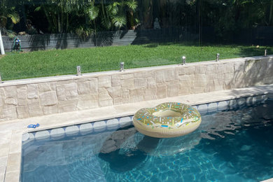 Design ideas for a mid-sized backyard rectangular pool in Sydney with with a pool and natural stone pavers.