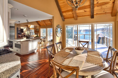 Kitchen/dining room combo - mid-sized rustic medium tone wood floor kitchen/dining room combo idea in New York with yellow walls and no fireplace
