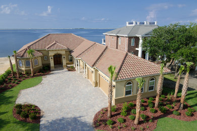 Inspiration for a timeless one-story stucco exterior home remodel in Miami with a hip roof
