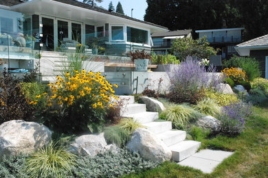 This is an example of a contemporary backyard full sun formal garden in Vancouver with a garden path and concrete pavers.
