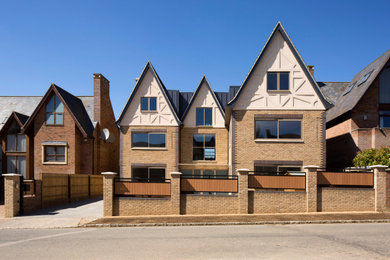 Inspiration for a large modern brick semi-detached house in Buckinghamshire with three floors, a pitched roof and a tiled roof.