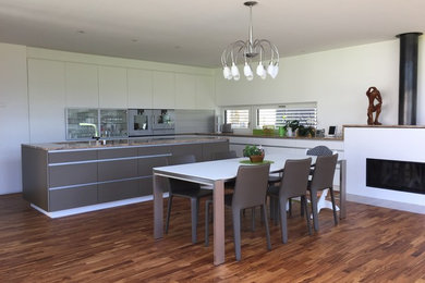 Photo of a contemporary kitchen in Cologne with medium hardwood floors and beige floor.