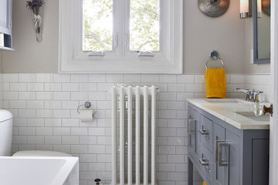 Photo of a bathroom in Toronto with white tile, an undermount sink and white benchtops.