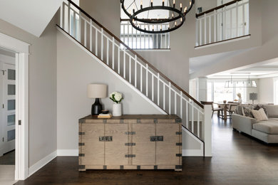 Example of a mid-sized transitional dark wood floor and brown floor entryway design in Minneapolis with beige walls and a brown front door
