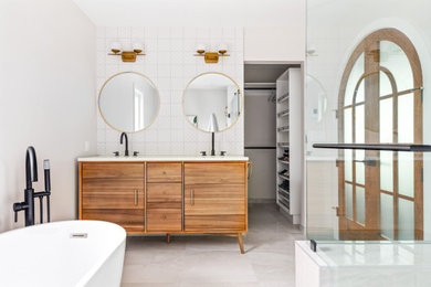 Bathroom - mid-sized 1950s master white tile and ceramic tile ceramic tile, gray floor and double-sink bathroom idea in Calgary with flat-panel cabinets, medium tone wood cabinets, white walls, an undermount sink, quartz countertops, a hinged shower door, white countertops, a niche and a freestanding vanity