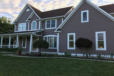 Example of a large classic brown two-story wood exterior home design in Indianapolis with a shingle roof