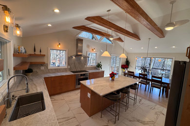 Kitchen - large modern porcelain tile kitchen idea in New York with an undermount sink, flat-panel cabinets, medium tone wood cabinets, quartzite countertops, gray backsplash, quartz backsplash, stainless steel appliances, an island and gray countertops