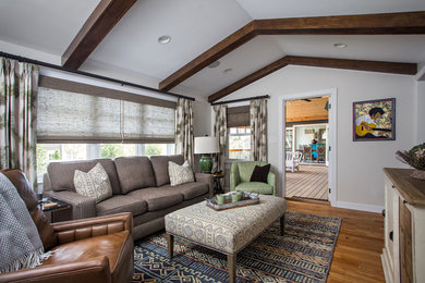Large eclectic loft-style medium tone wood floor and brown floor family room photo in Charlotte with white walls, no fireplace and no tv