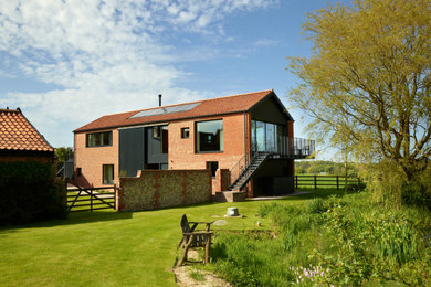 Photo of a country two floor brick detached house in Other.