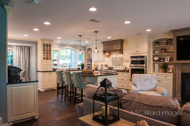Large elegant l-shaped kitchen photo in Newark with raised-panel cabinets and an island