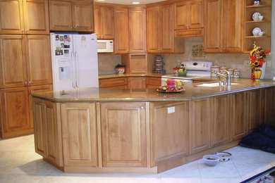 Mid-sized elegant u-shaped porcelain tile open concept kitchen photo in Orange County with an undermount sink, raised-panel cabinets, light wood cabinets, granite countertops, beige backsplash, stone tile backsplash, white appliances and no island