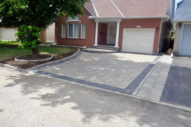 Inspiration for a modern front yard concrete paver driveway in Ottawa.