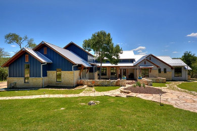 Inspiration for a huge eclectic blue two-story mixed siding exterior home remodel in Austin with a metal roof
