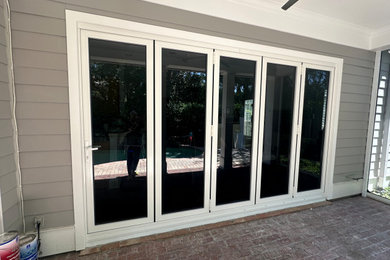 Inspiration for a huge contemporary backyard concrete paver patio remodel in Tampa with a roof extension