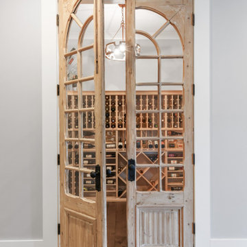 Rustic Wine Cellar & Designer Walk-In Pantry Behind Arched Doors