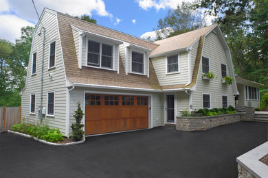 Large elegant white two-story wood exterior home photo in Boston with a gambrel roof