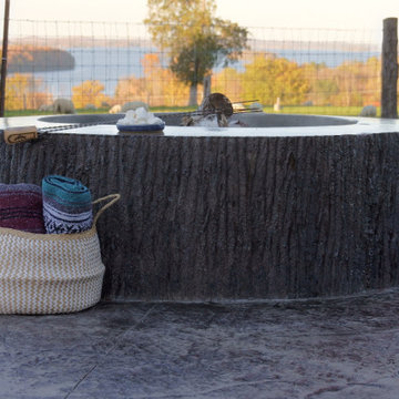 Concrete fire pit with stamped stone pad