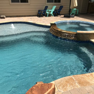 Cozy Lagoon pool with jump rocks and waterfall