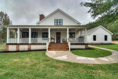 Country white two-story concrete fiberboard and clapboard exterior home photo in Other with a shingle roof and a brown roof