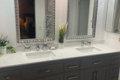 Example of a minimalist master double-sink bathroom design in Los Angeles with gray cabinets, quartz countertops, white countertops and a built-in vanity
