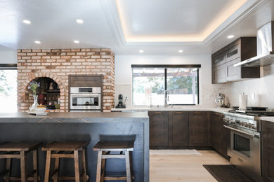 Large urban l-shaped eat-in kitchen photo in San Francisco with shaker cabinets, dark wood cabinets, quartz countertops, white backsplash, quartz backsplash, stainless steel appliances, an island and white countertops