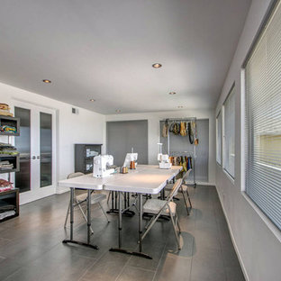 This is an example of a mid-sized contemporary craft room in San Diego with white walls, a freestanding desk, porcelain floors and no fireplace.