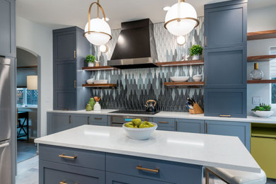 Example of a mid-sized transitional u-shaped gray floor kitchen design in Portland with an undermount sink, shaker cabinets, blue cabinets, quartz countertops, multicolored backsplash, porcelain backsplash, stainless steel appliances, an island and white countertops