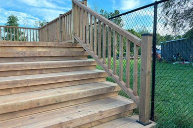 Deck - mid-sized country backyard wood railing deck idea in Toronto