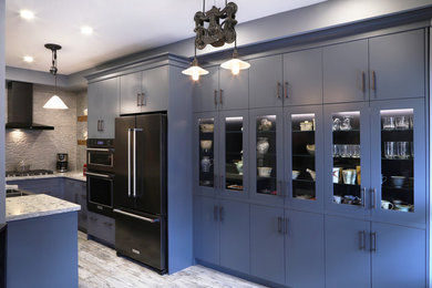 Mid-sized minimalist u-shaped porcelain tile and beige floor enclosed kitchen photo with a farmhouse sink, flat-panel cabinets, gray cabinets, quartzite countertops, gray backsplash, stone tile backsplash, stainless steel appliances and no island