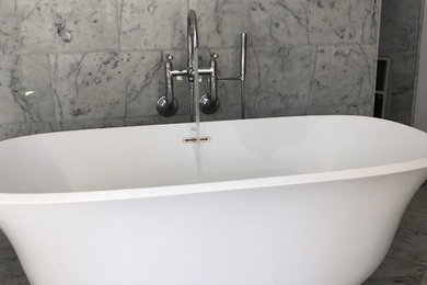 Freestanding tub with wall mount faucets